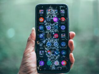 Crop anonymous person using mobile phone with various apps for social network and internet